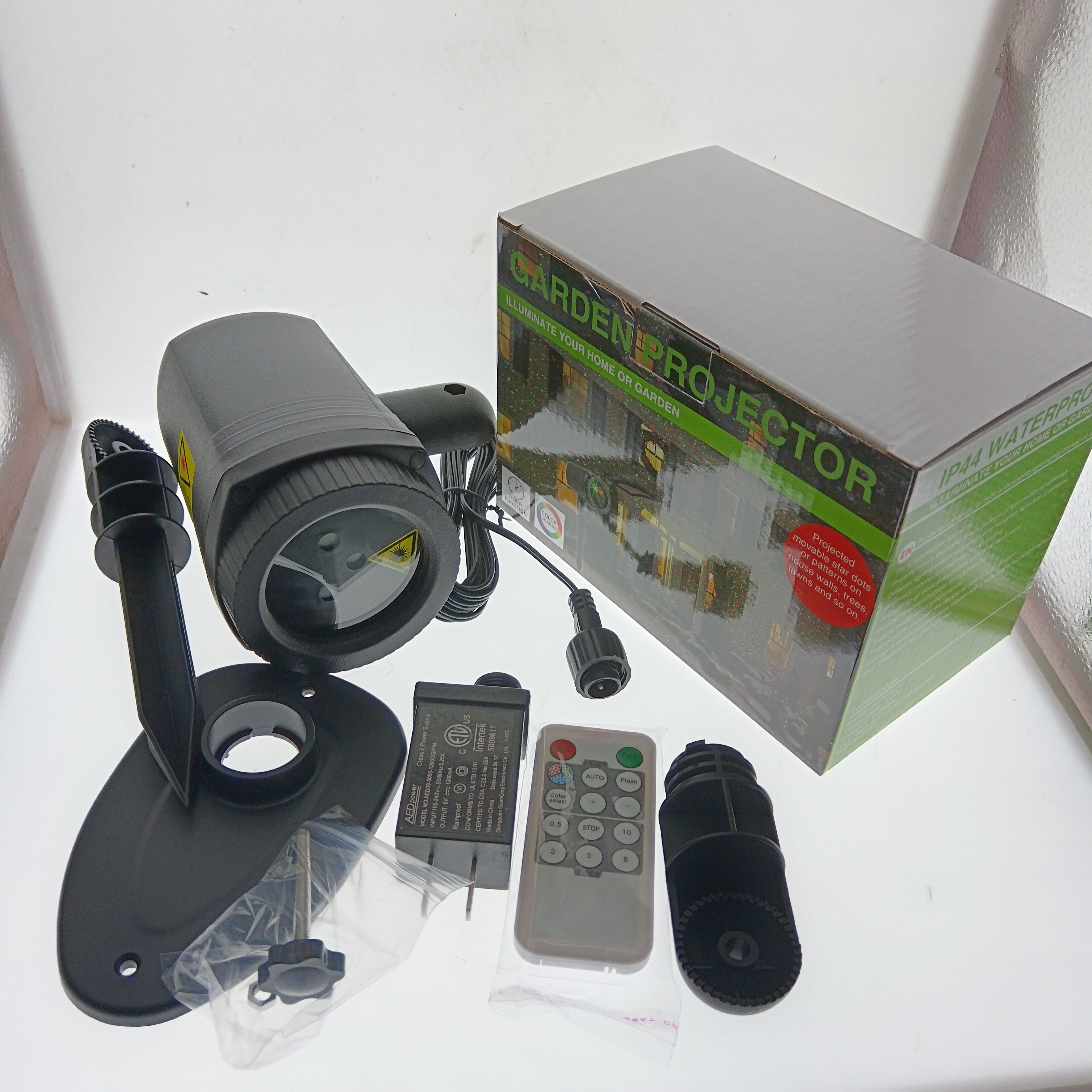 Proyector de luz láser de luciérnagas para exteriores, impermeable, lámpara de jardín estrellado con control remoto, acabado de plástico cepillado, montaje semiempotrado, batería de botón no recargable, enchufe de EE. UU., Ideal para Halloween, festivale