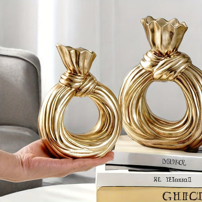 Una botella decorativa de resina, ideal para decoración de hogar contemporáneo, un jarrón minimalista nórdico bohemio para flores de pampa, con un diseño distintivo de lazo, apto para uso como jarrón o como regalo decorativo.